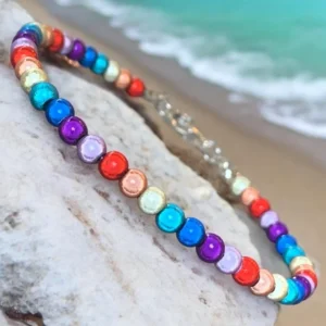 Colorful bracelet on rock by the beach.