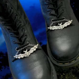 Black boots with silver bat accessories.