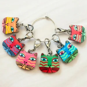 Colorful cat face keychains in a circle.