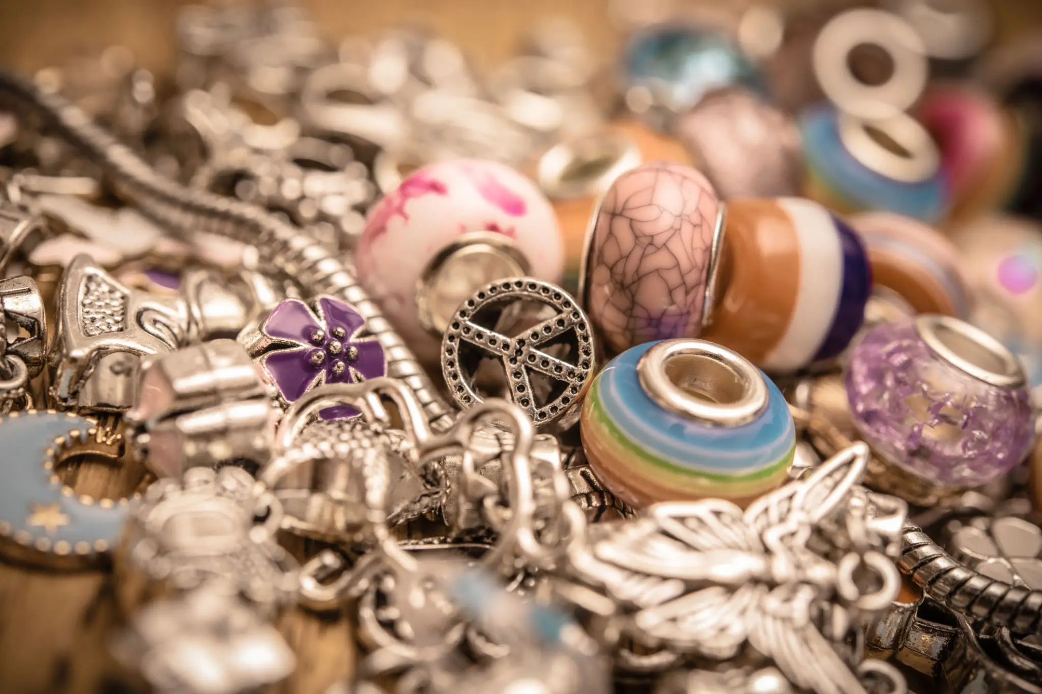 Close-up of colorful and metallic jewelry pieces clustered together.