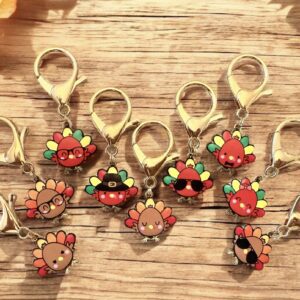 Handmade reindeer keychains with festive decorations on a wooden surface.