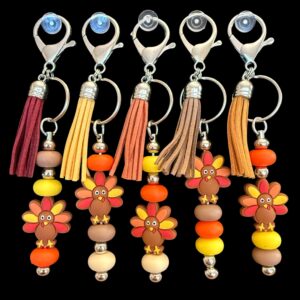 Colorful wooden bead keychains with tassels, each featuring a globe charm.