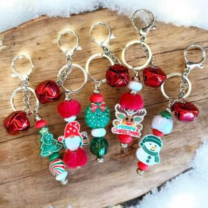 Festive Christmas keychains with Santa, snowmen, and candy cane charms.