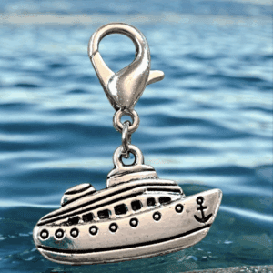 Silver submarine charm with clasp against a blue water background.