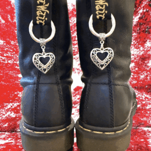 Black boots with heart-shaped keychain charms hanging from the back.