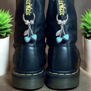 Black boots with butterfly charms and blue bows at the back.