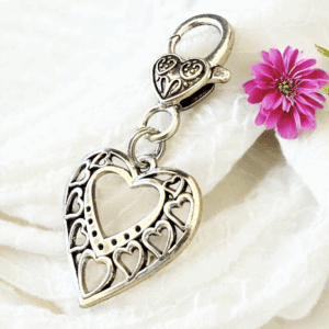 Elegant silver heart-shaped keychain with intricate designs.