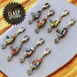 Colorful seahorse keychains with clasps arranged on a wooden surface.