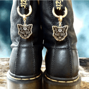 Black leather boots with wolf face charms on the back.