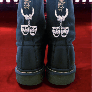 Black boots with comedy and tragedy mask patches on the back.