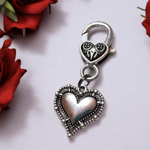 Elegant heart-shaped silver pendant with intricate detailing.