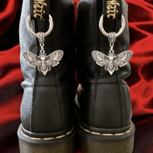 Black boots with silver butterfly charms hanging at the back.
