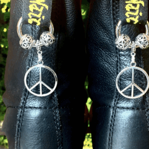 Black leather boots with peace sign charms and leopard print bows.