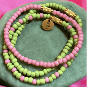 Colorful beaded necklace with pink, green, and brown beads.