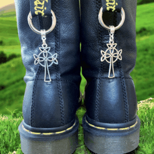 Black boots with silver cross keychains hanging from the laces.