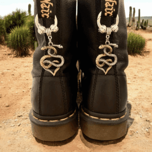 Black boots with decorative silver chains and heart-shaped charms.