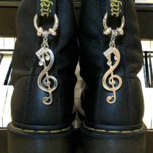 Black boots with silver treble clef charms attached to the back.