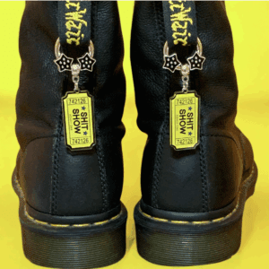 Black boots with yellow tags attached to the back loops.