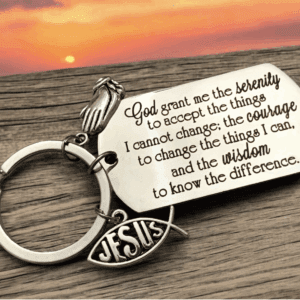 A Christian keychain with an inspirational Bible quote and sunset background.