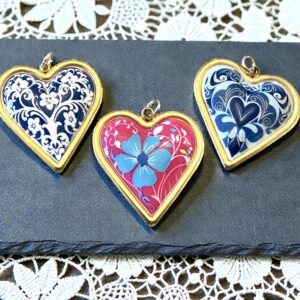 Three decorative heart-shaped pendants with intricate patterns.